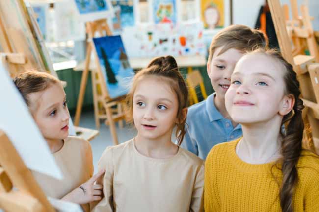 Four young children smiling